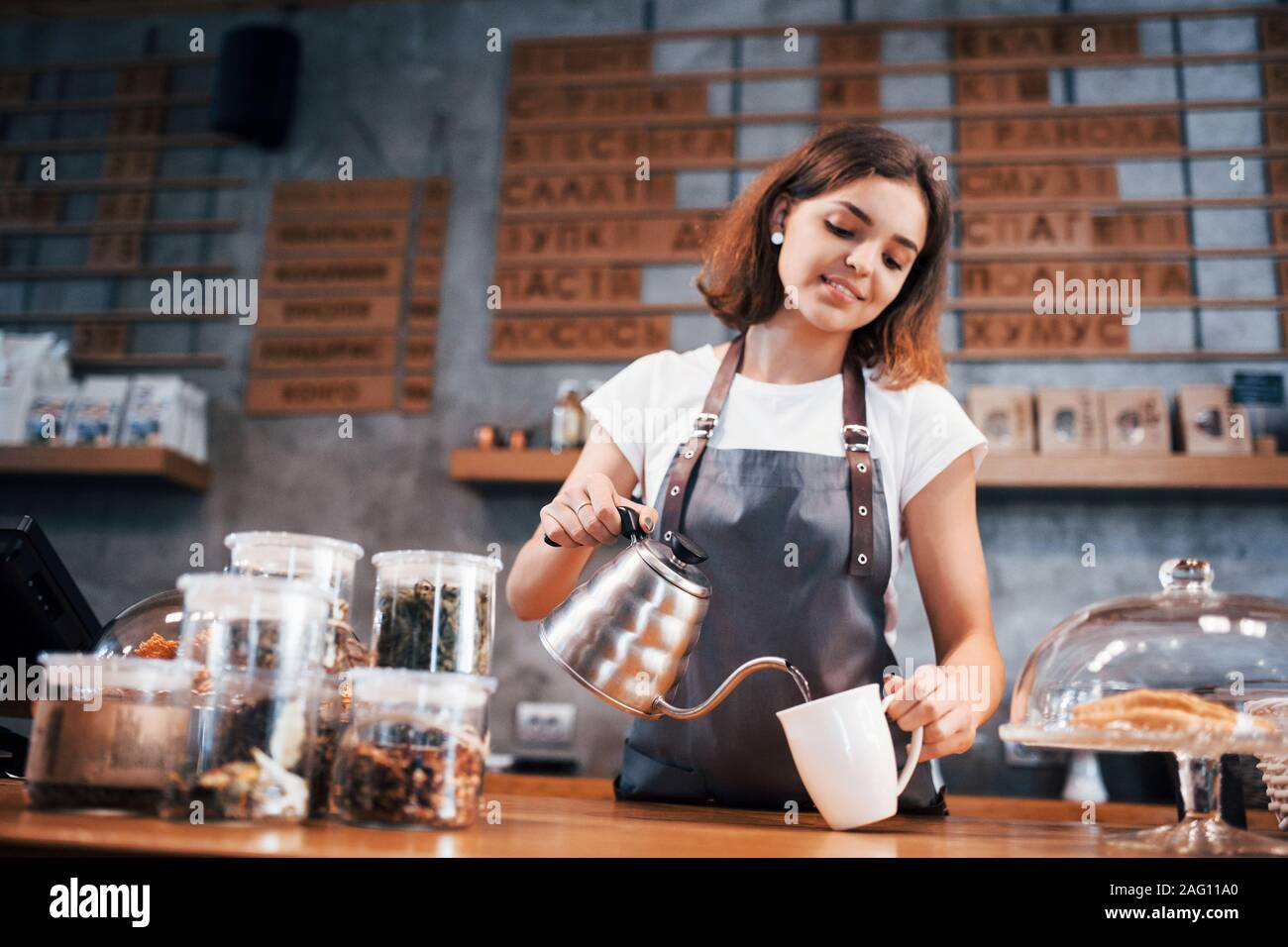 When you love your job. Young female cafe worker indoors. Conception of