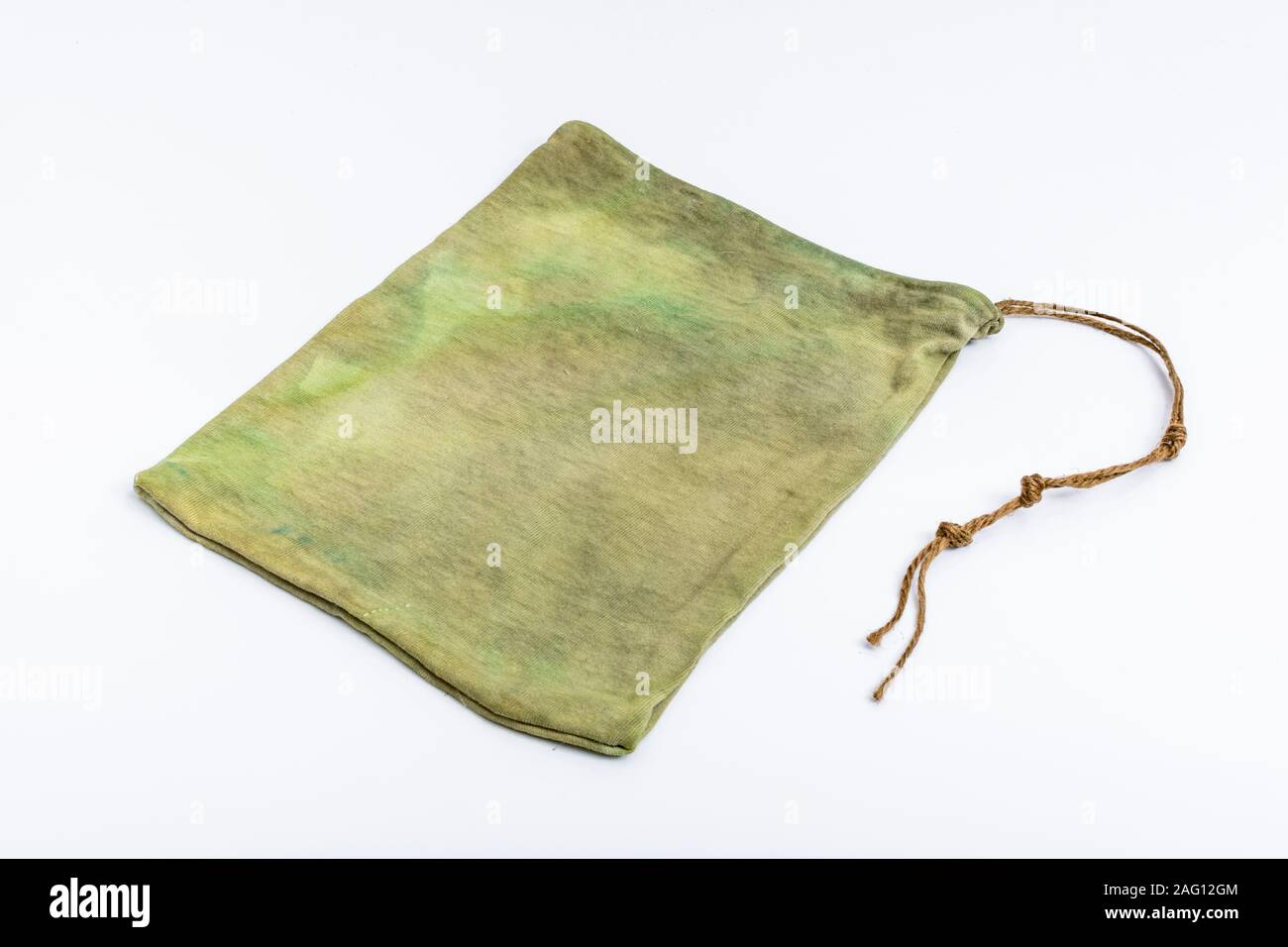 Small rustic possibles bag / ditty bag on off-white plain background. Metaphor survival skills, survival knowledge, bushcraft. Stock Photo
