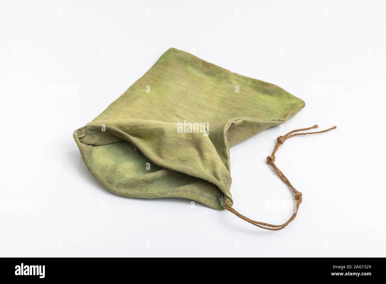 Small rustic possibles bag / ditty bag on off-white plain background. Metaphor survival skills, survival knowledge, bushcraft. Stock Photo
