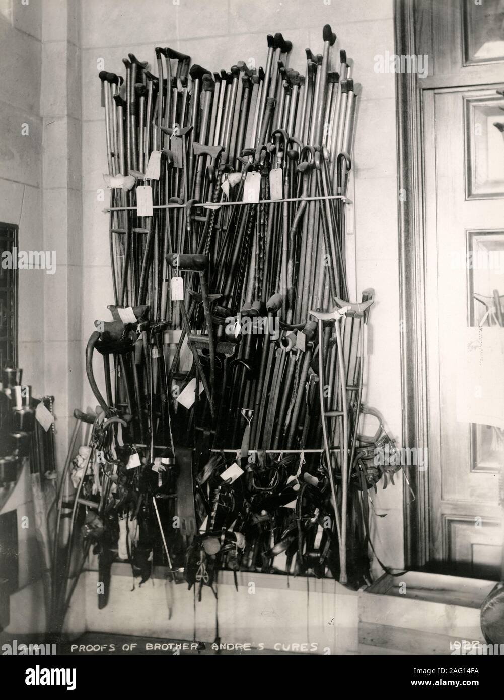 Early 20th century vintage press photograph - walking sticks, proof of the cures of Brother Andre - Alfred Bessette of Quebec, a member of the Saint Croix Order, who became Canada's first Catholic saint. Stock Photo