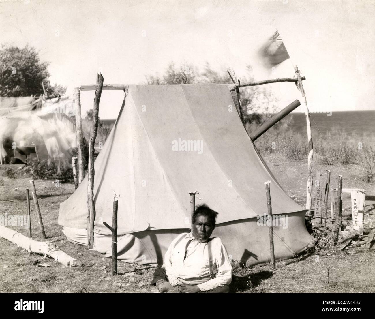 Early 20th century vintage press photograph - native north American outside his tent, Canada Stock Photo