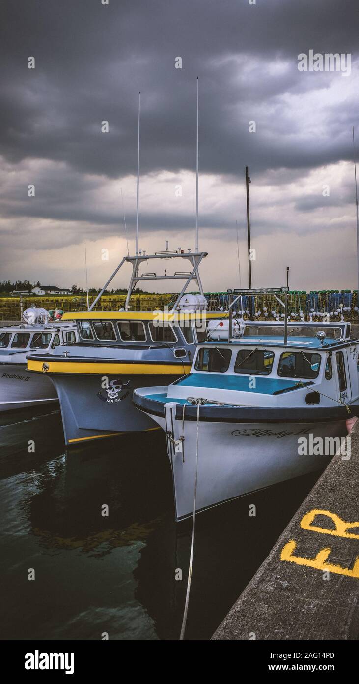 Docked fishing boats with storm clouds Stock Photo