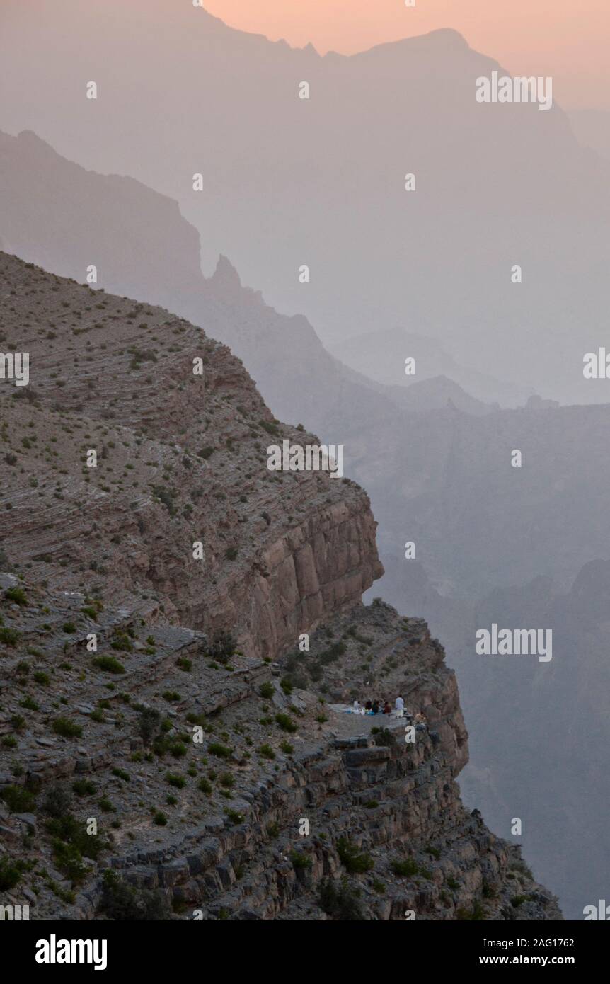 Omani family dine on cliff top Stock Photo