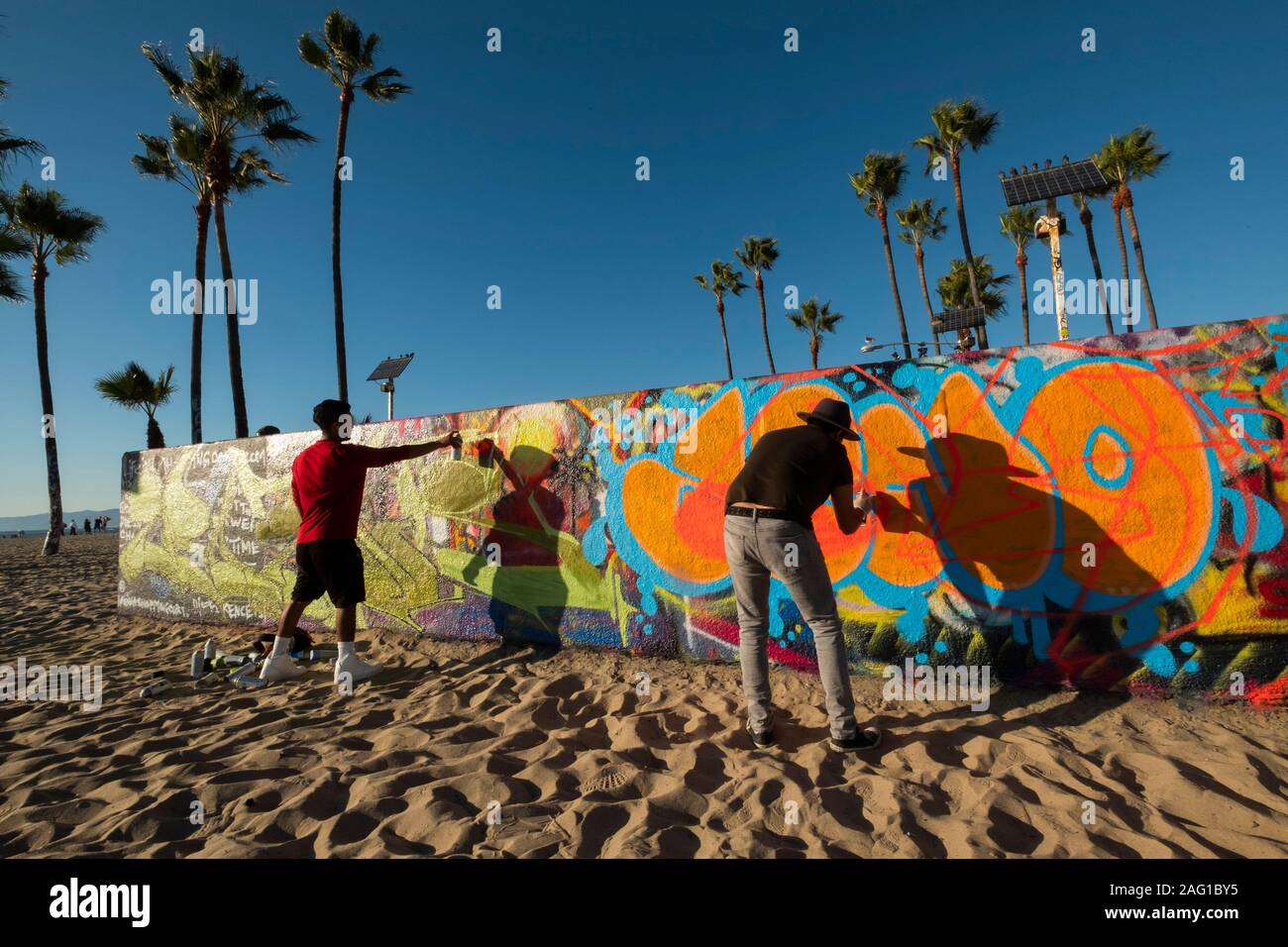 Graffiti artists tag a wall in Venice Beach, Los Angeles, California