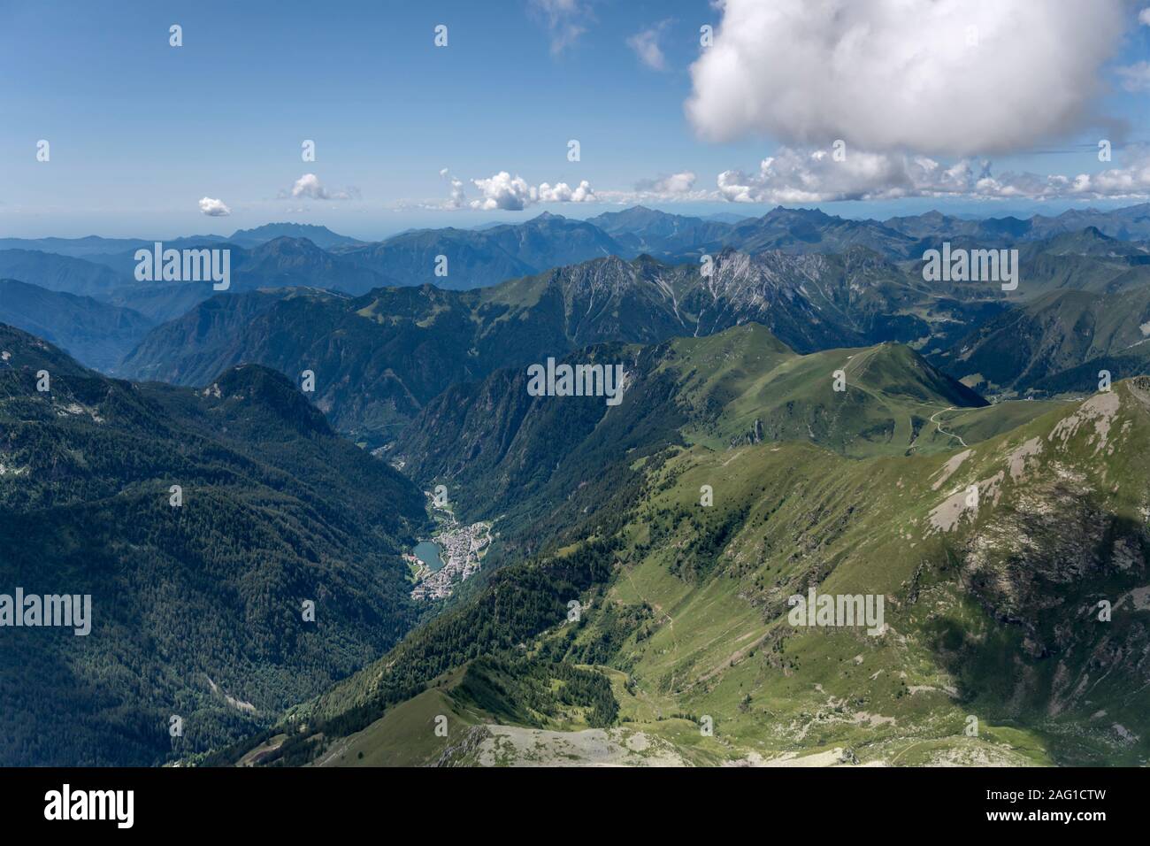 aerial, from a small plane, of Carona valley and village in Orobie mountains, shot in bright summer light, near Carona, Lombardy , Italy Stock Photo