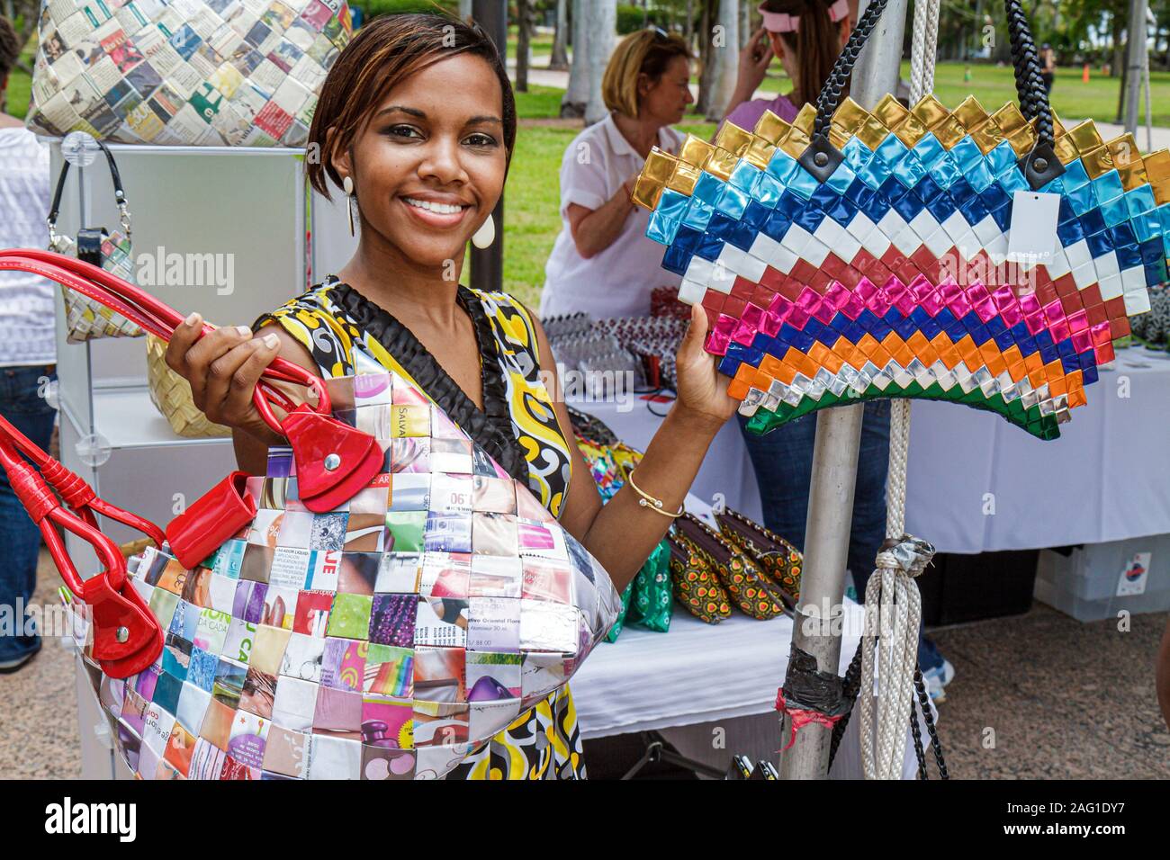 Miami Florida,Bayfront Park,Miami Goin' Green,Earth Day,festival,eco friendly,exhibitor,Black woman female women,handbags purses pocketbookx,recycled, Stock Photo