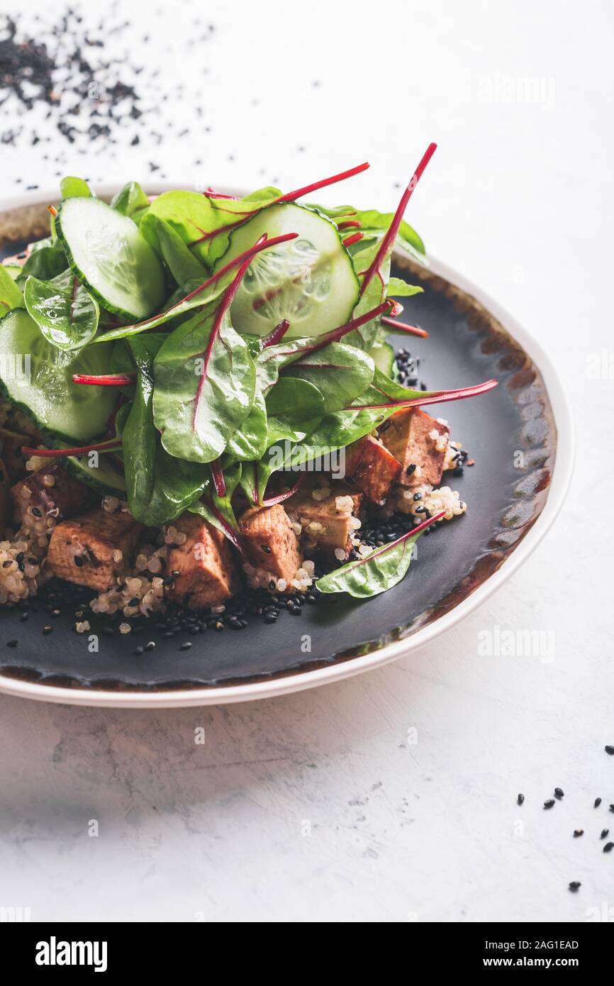 Vegan green marinated tofu poke bowl with baby chard, cucumber and