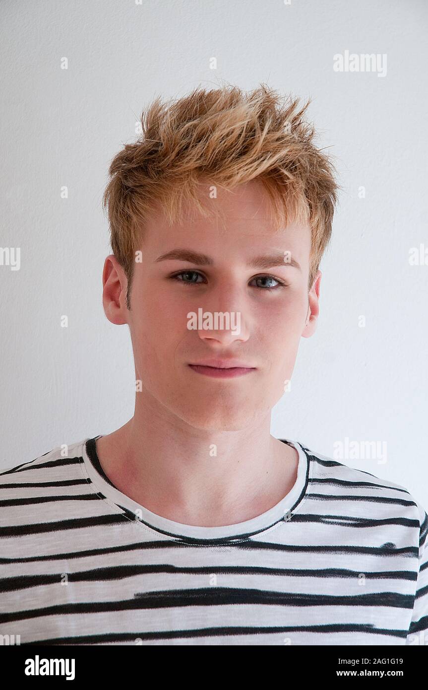 Portrait of young man wearing stripped shirt, looking at the camera. Close view. Stock Photo