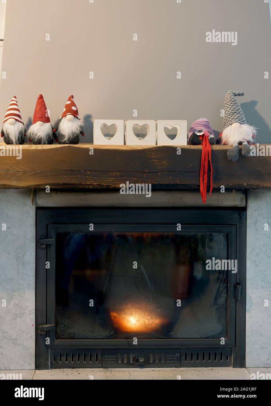 marble fireplace with a wooden beam decorated with Christmas decorations Stock Photo