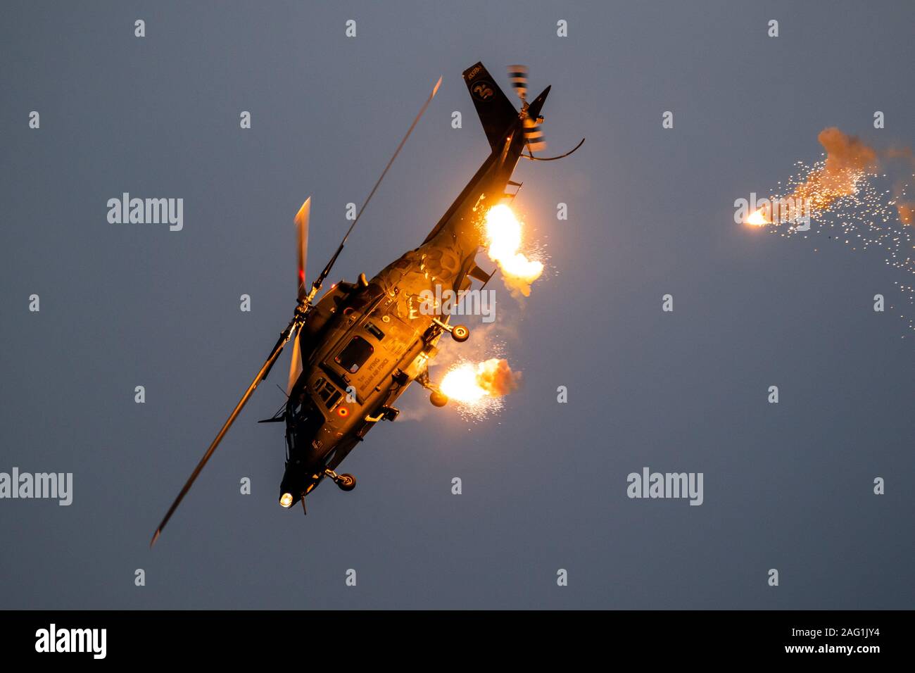SANICOLE, BELGIUM - SEP 13, 2019: Belgian Air Force Agusta A109 helicopter firing flares during a flight demonstration at the Sanice Sunset Airshow Stock Photo