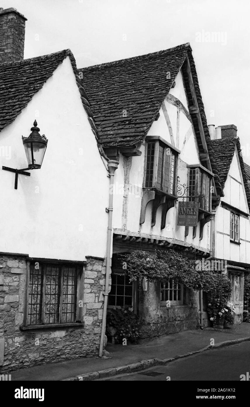 The C15th Sign of the Angel in the ancient village of Lacock, Wiltshire: the village is owned by the National Trust, and often used as a film set, including for Harry Potter and the Half Blood Prince.  Black and white version Stock Photo