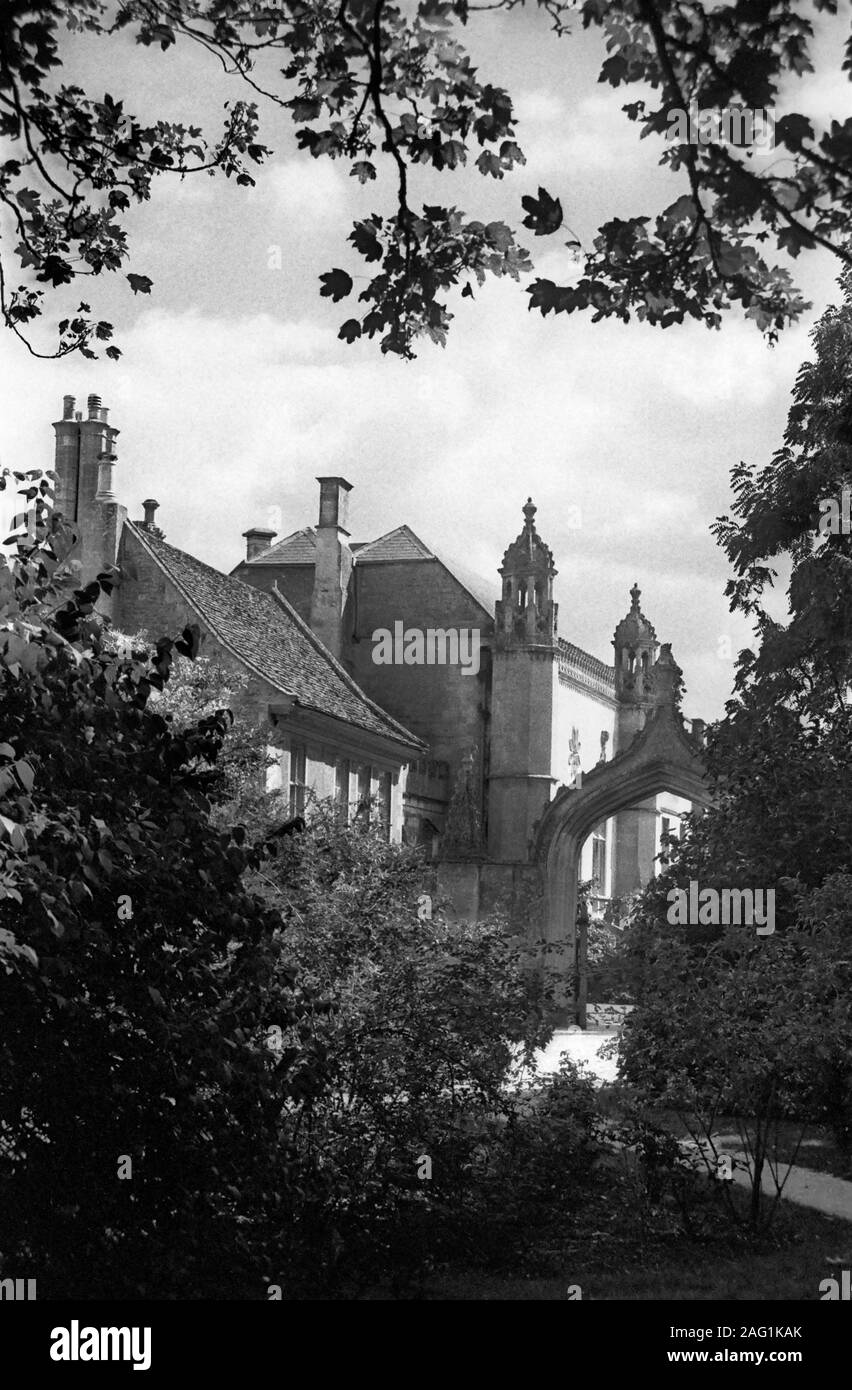 Lacock Abbey: Gothic archway and remodelled entrance in the Gothick style by Sanderson Miller in the 18th century.  Black and white old film photograph Stock Photo