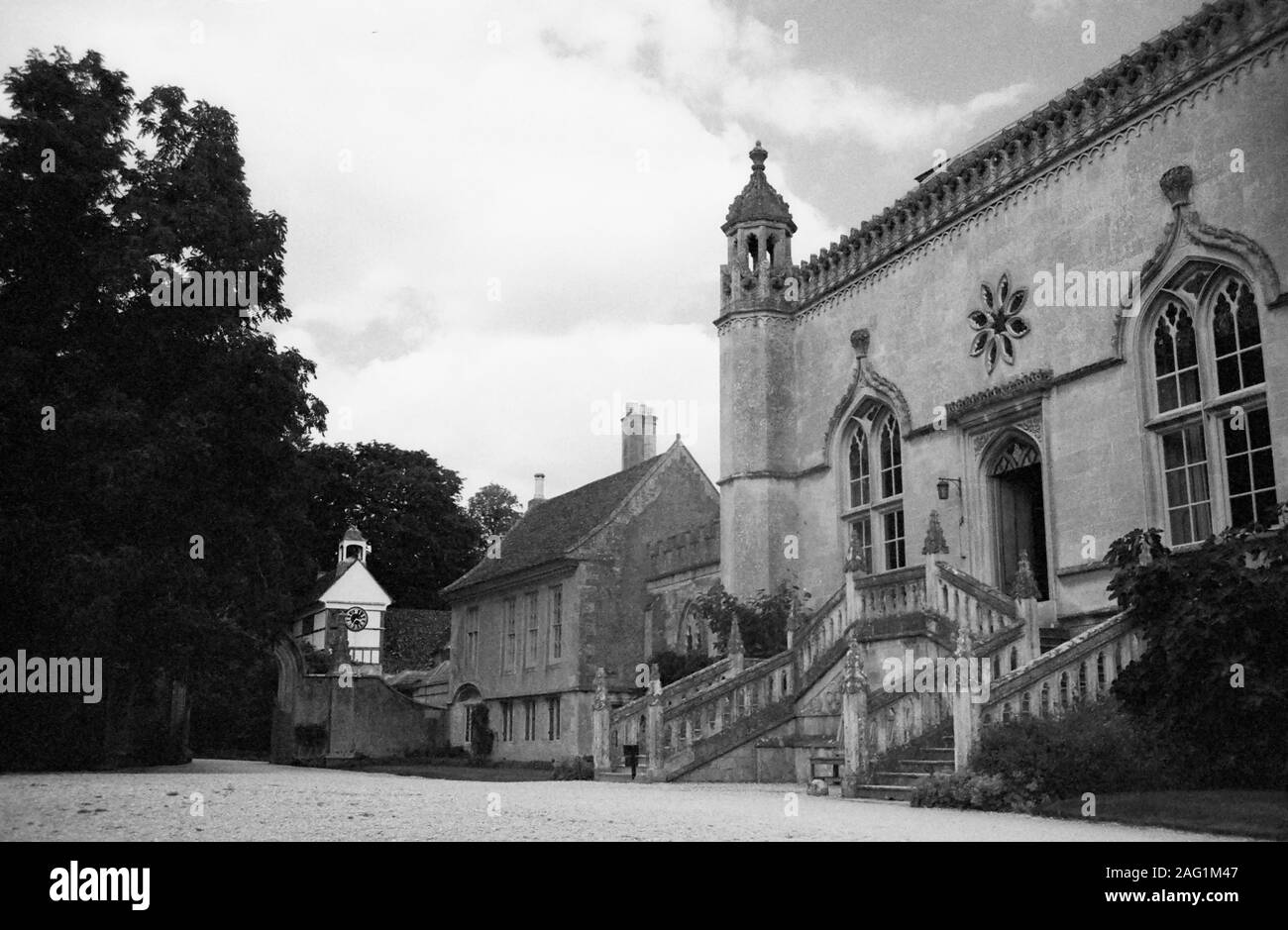 Lacock Abbey: main entrance with double flight of stairs to the main door: remodelling in the Gothick style by Sanderson Miller in the 18th century.  Black and white old film photograph Stock Photo