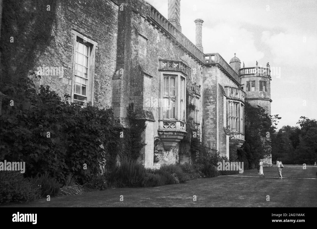 Lacock Abbey, Lacock, Wiltshire, England, UK: south elevation with oriel windows and Sharington's Tower at the end.  Old black and white film photograph Stock Photo