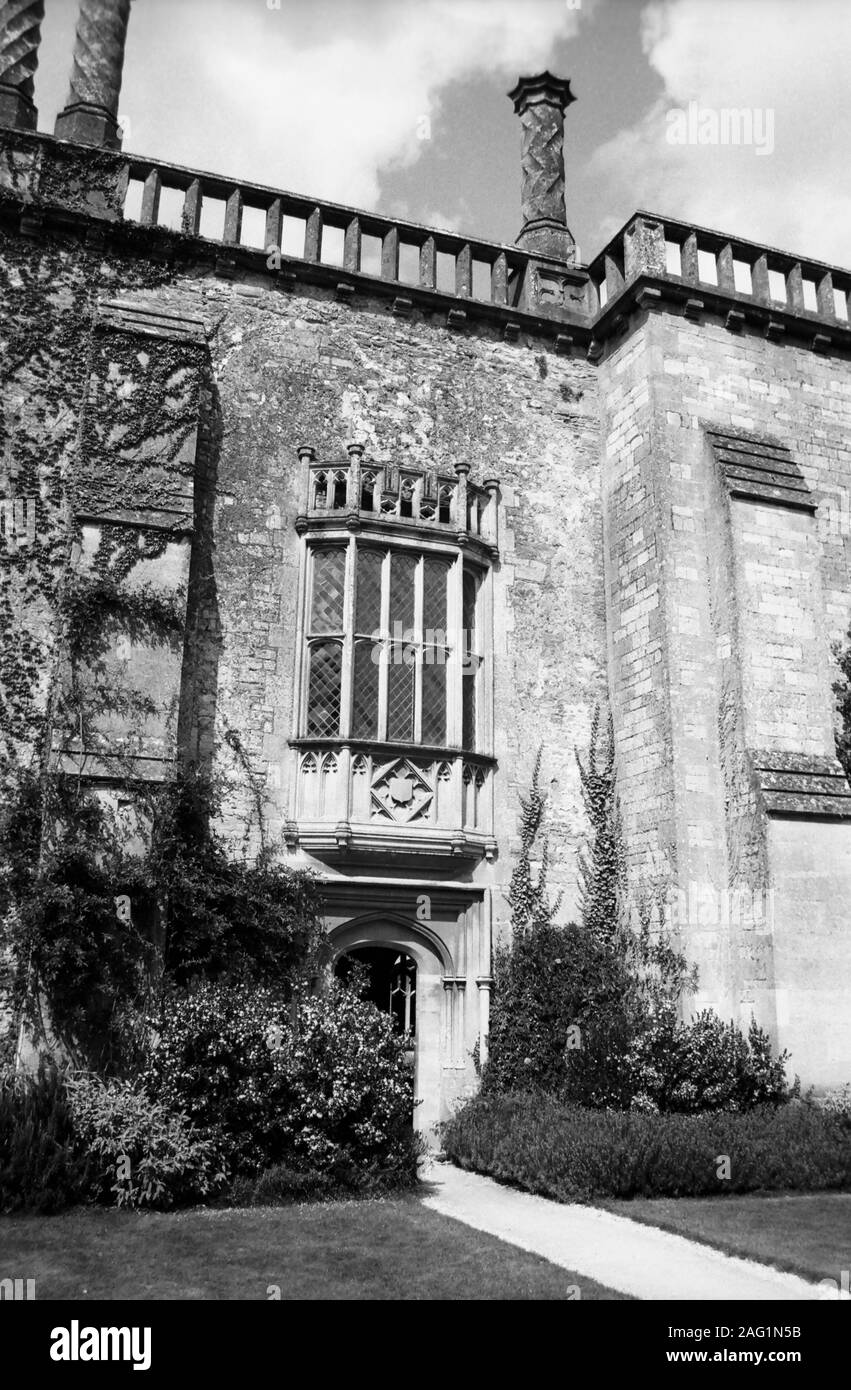 Lacock Abbey, Lacock, Wiltshire, England, UK: south elevation with old door to the cloisters and mullioned window above: the window featured in Henry Fox Talbot's ground-breaking first negative photograph of 1835.  Old black and white film photograph Stock Photo