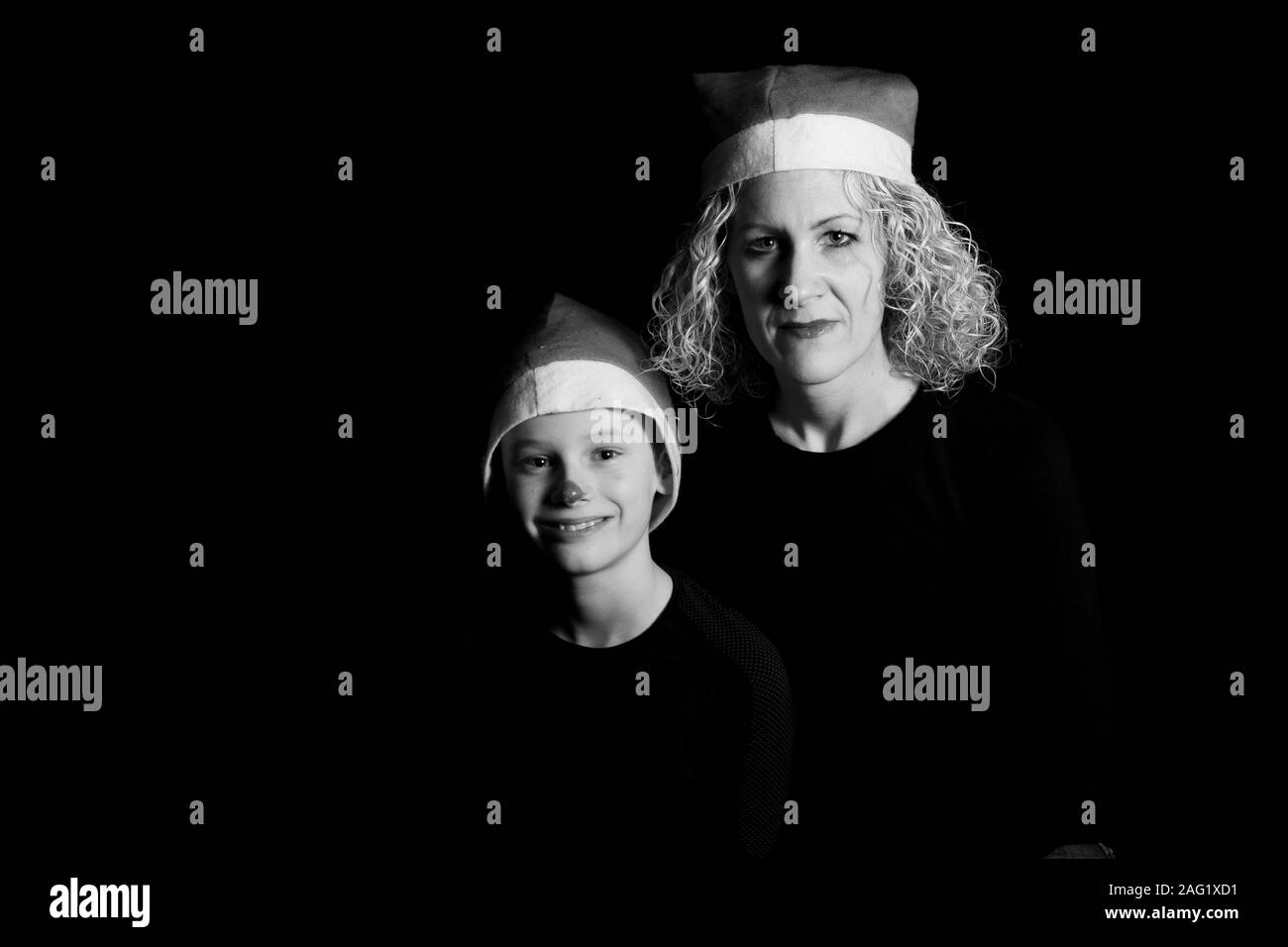 Boy and mother with Christmas hat in black and white Stock Photo