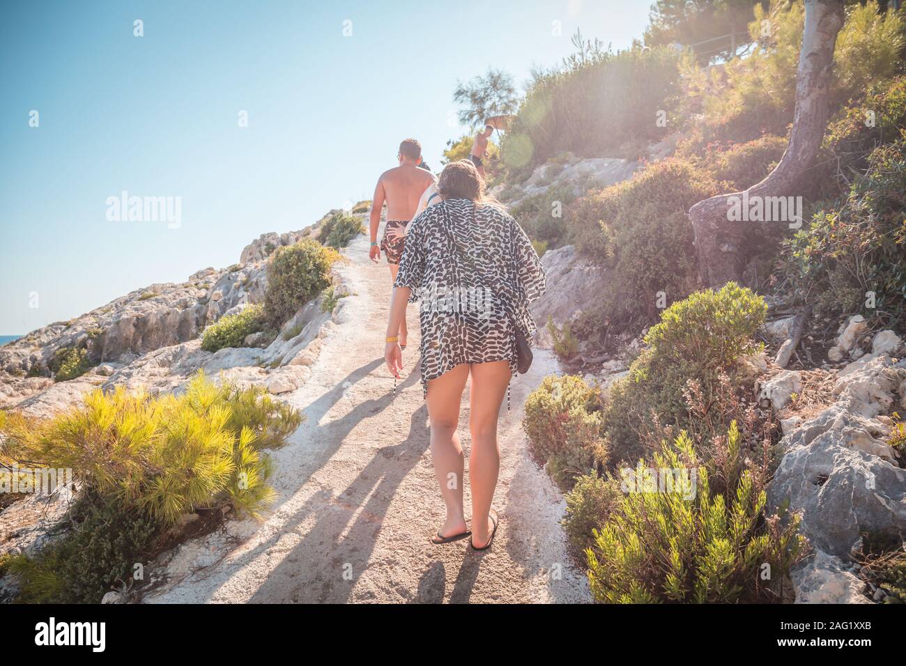 Zakynthos, Greece, August 2019 - Path from Beach in Porto Limnionas beach on Zakynthos island. Young woman and man on a way from beach. Stock Photo
