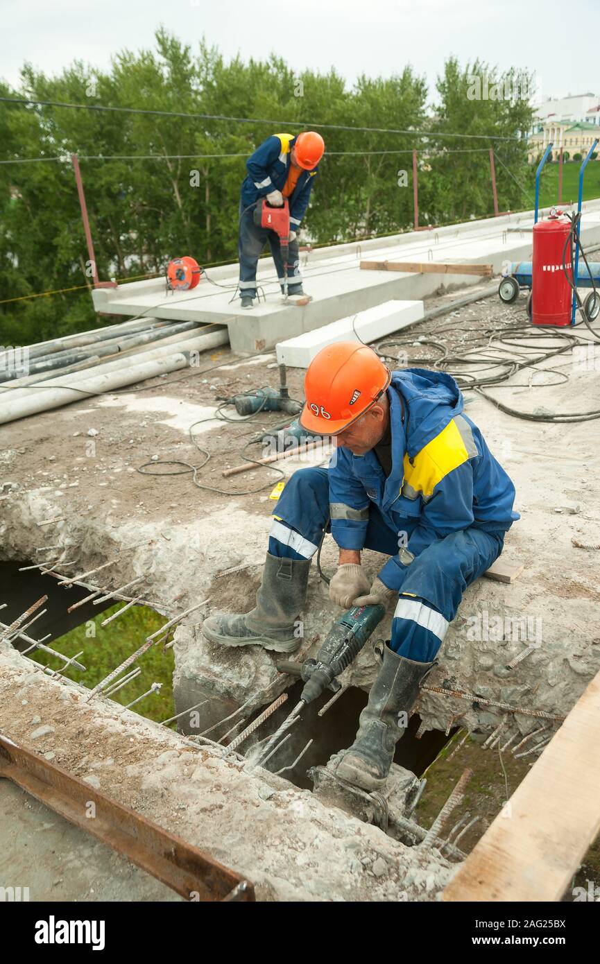 Worker with jackhammer to break up concrete Stock Photo