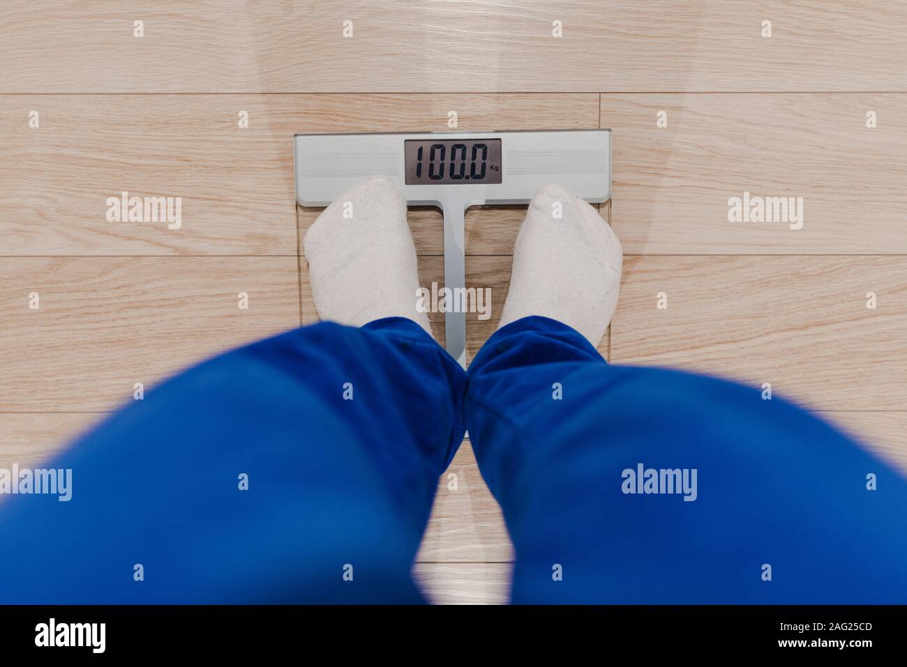 Legs in white socks stand on mechanical scales of blue color (front view  Stock Photo - Alamy