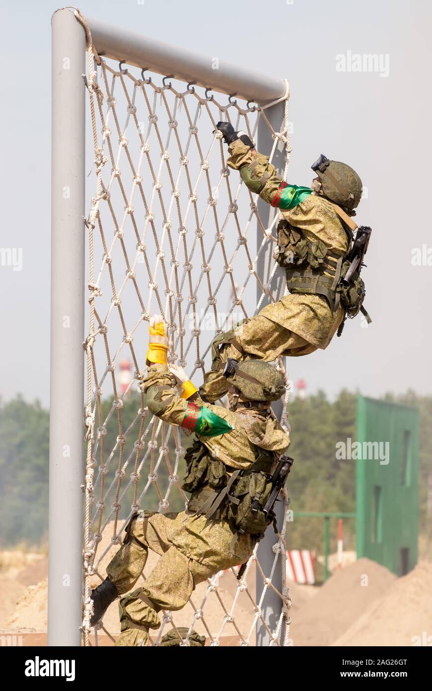 Military officers climbing rope net on Army Games Stock Photo - Alamy