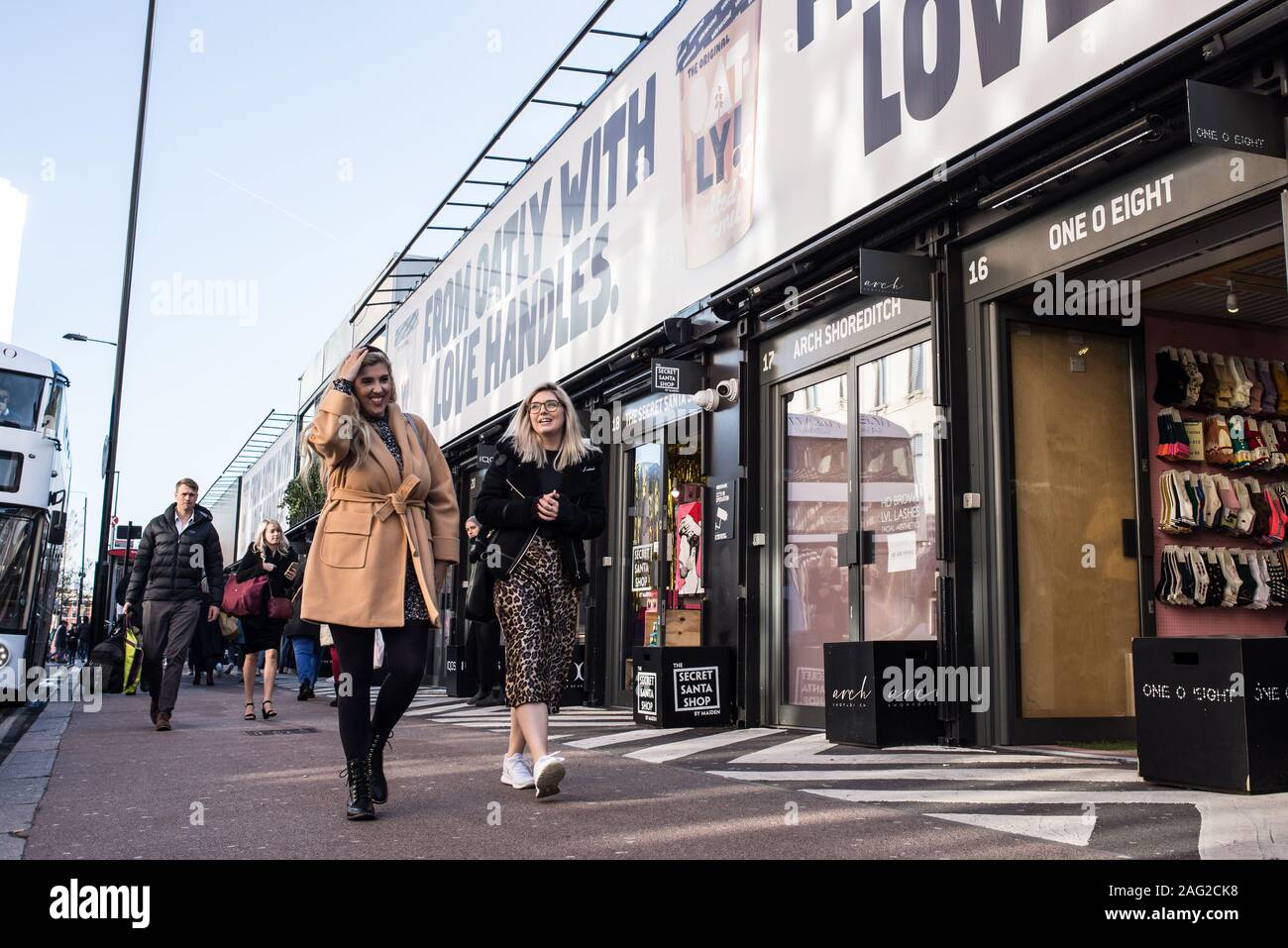 London, England - November 2019: People walking and shopping at the BOXPARK, a cool pop up shopping venue with several indie shops and bars Stock Photo