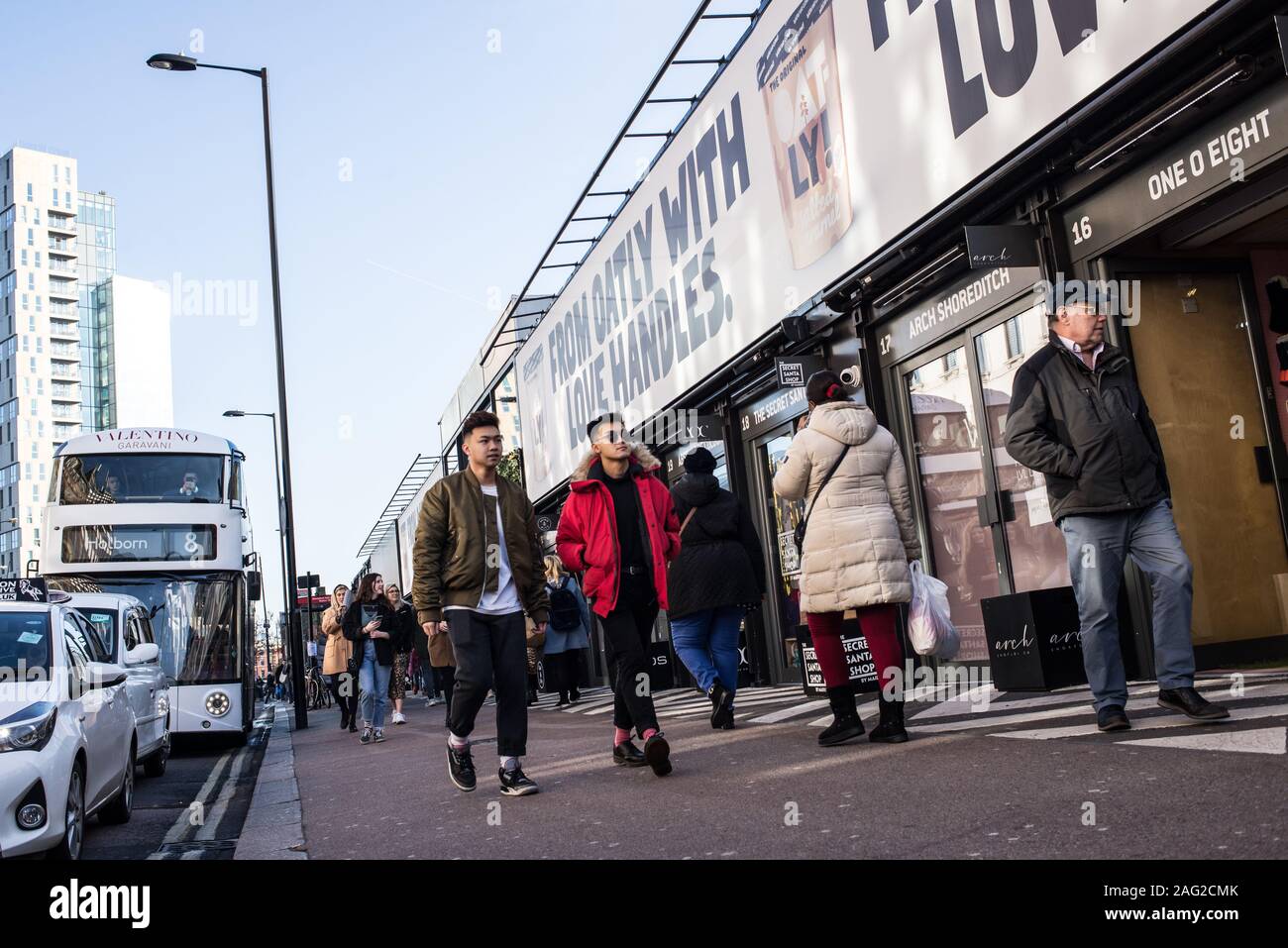 London, England - November 2019: People walking and shopping at the BOXPARK, a cool pop up shopping venue with several indie shops and bars in Shoredi Stock Photo