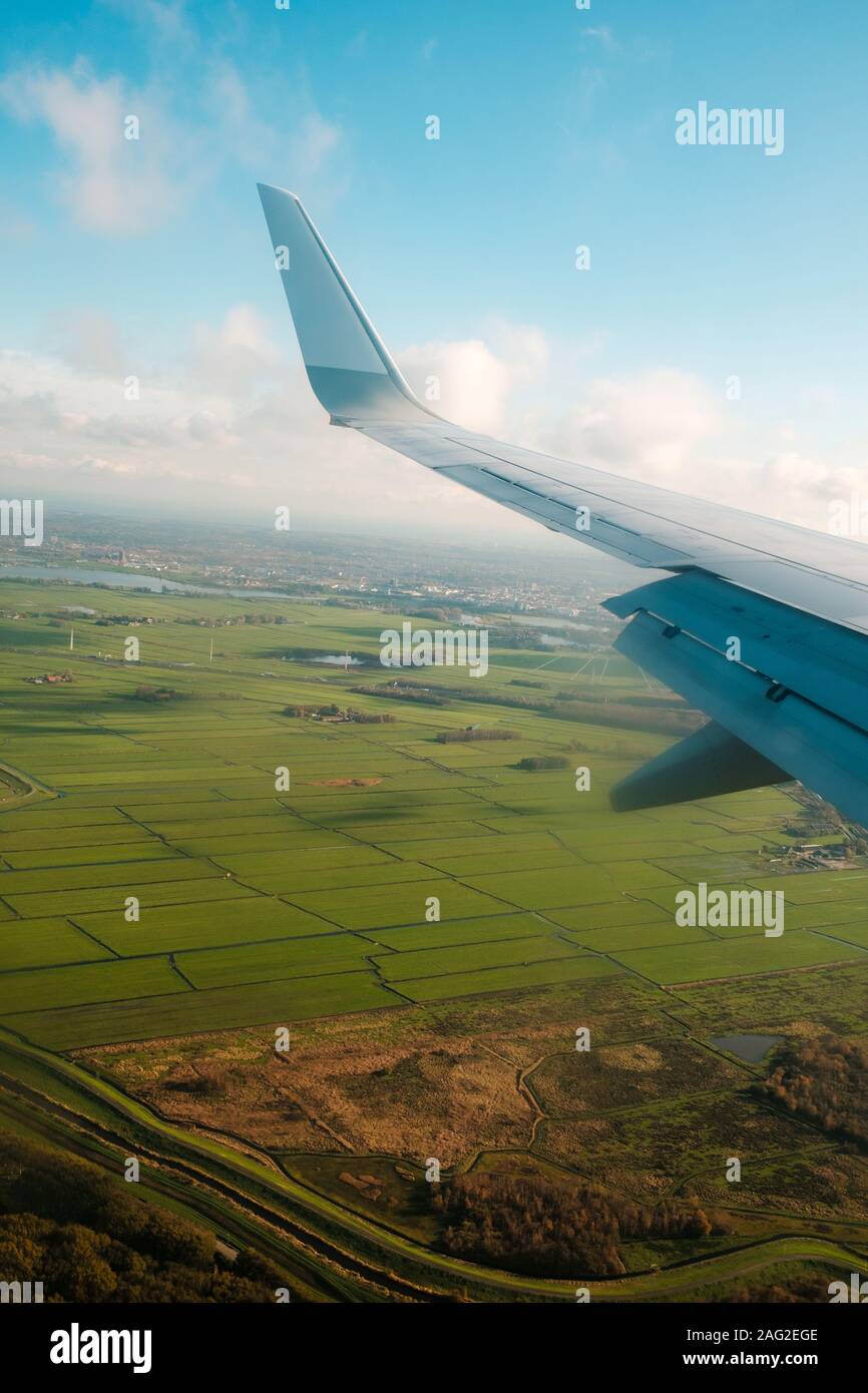 aiplane window view with ariplane wing and landscape aerial Stock Photo