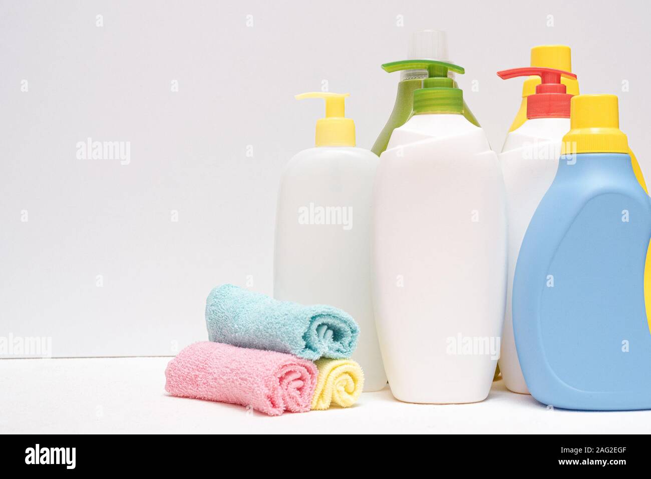 Detergent bottle and towels on white background Stock Photo - Alamy