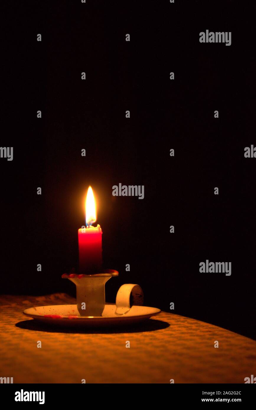 Candle light on a table, shining in the dark. Power outage, blackout  concept background Stock Photo - Alamy