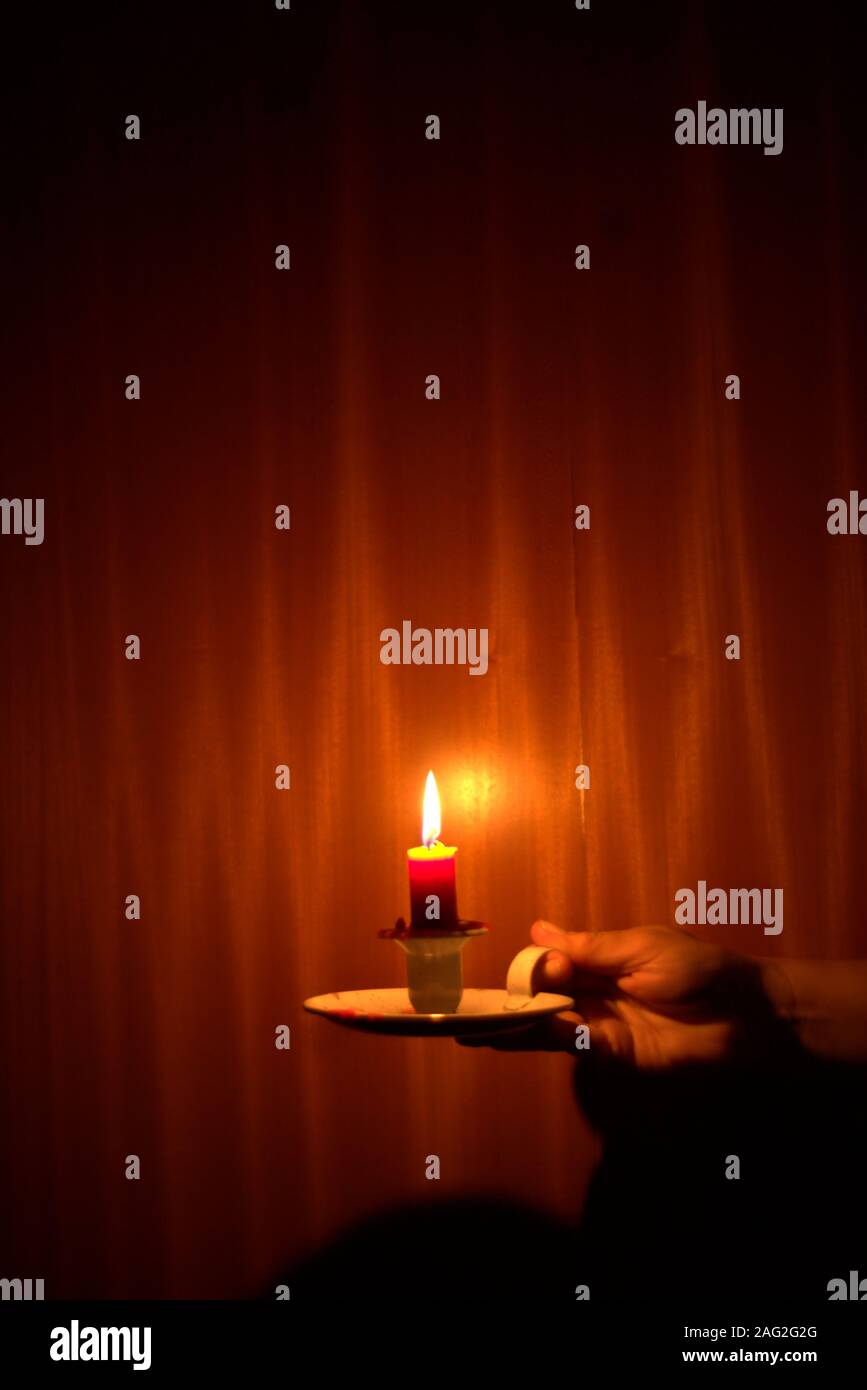 https://c8.alamy.com/comp/2AG2G2G/candle-light-shining-in-the-dark-against-wood-background-power-outage-blackout-concept-2AG2G2G.jpg