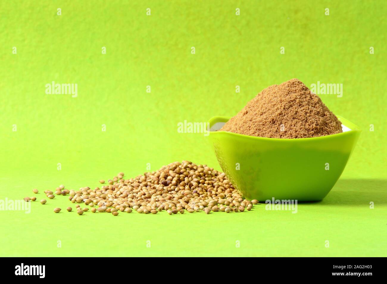Coriander seeds and Powdered coriander in green container on green