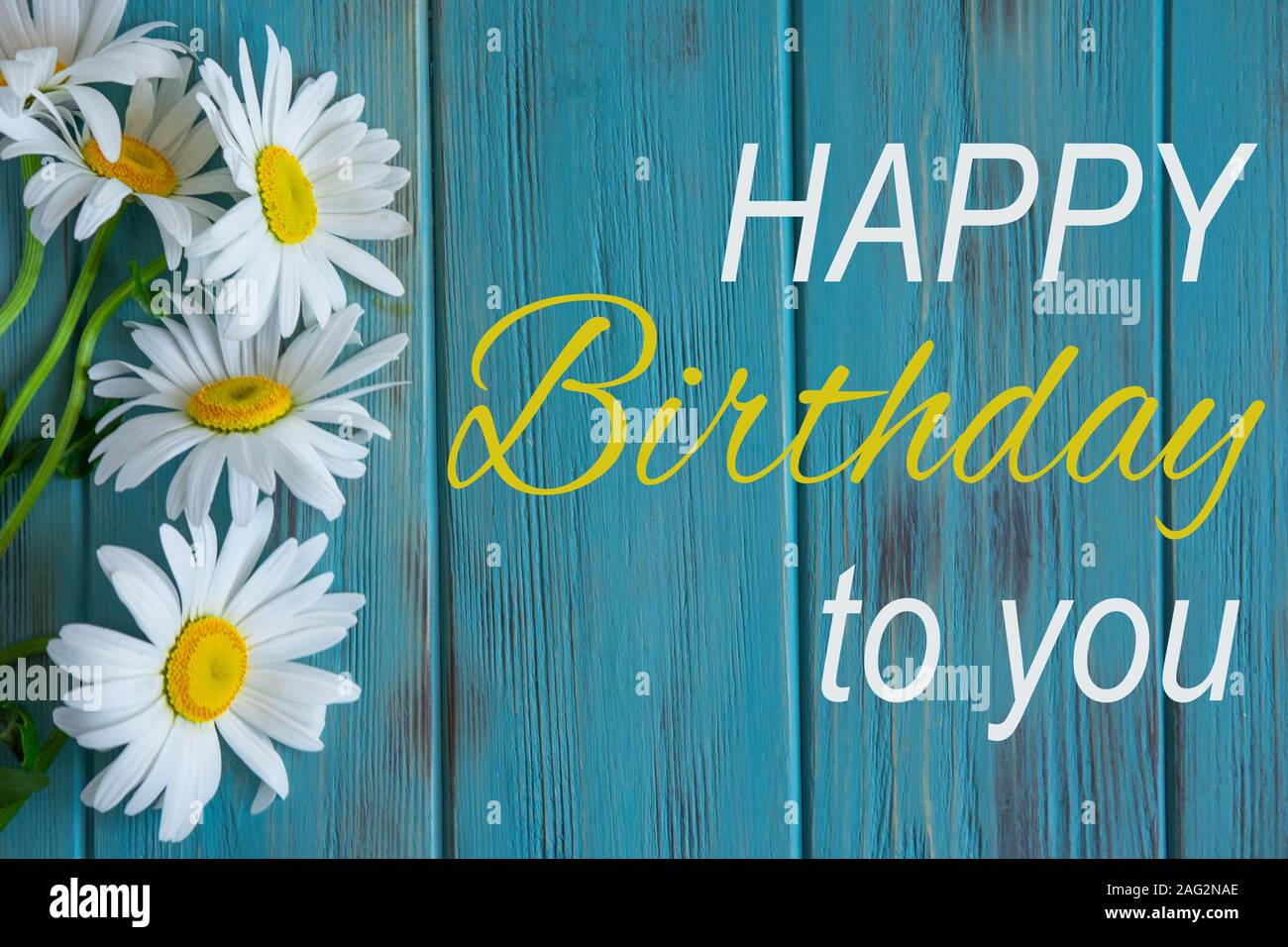 Happy birthday greeting card with camomile flowers on wooden background  Stock Photo - Alamy