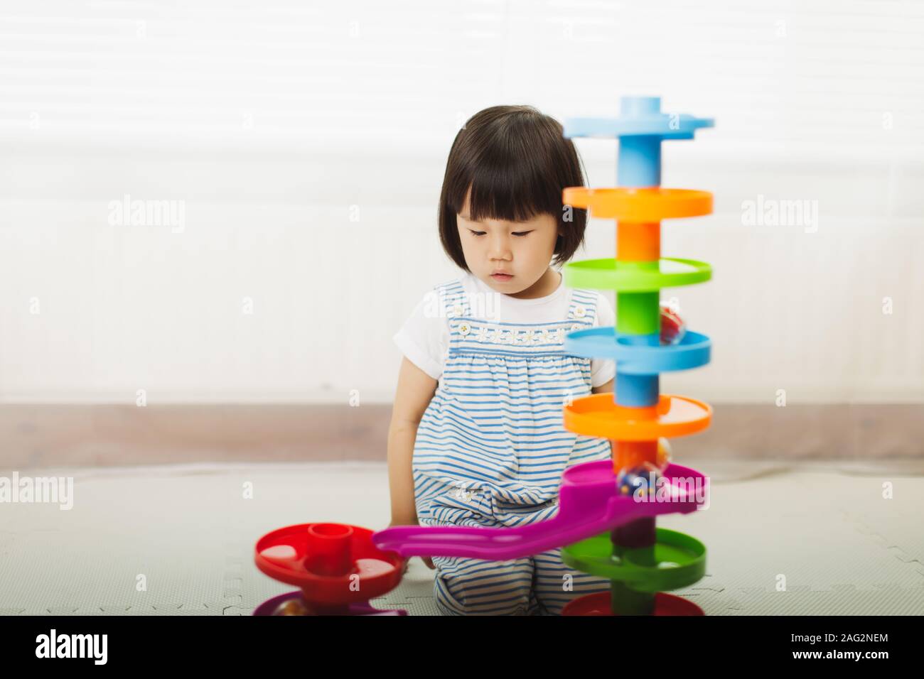 toddler girl play stack ball game at home Stock Photo Alamy