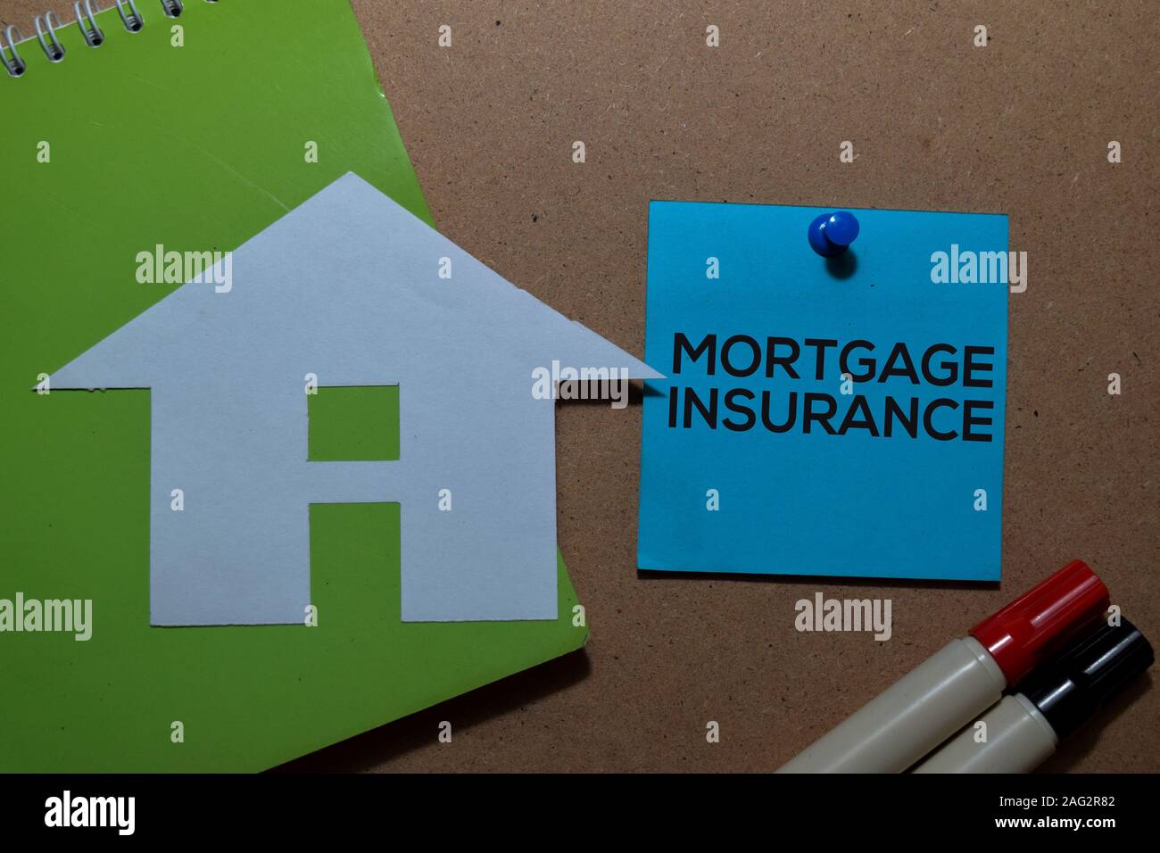 Mortgage Insurance write on sticky notes isolated on Office Desk Stock