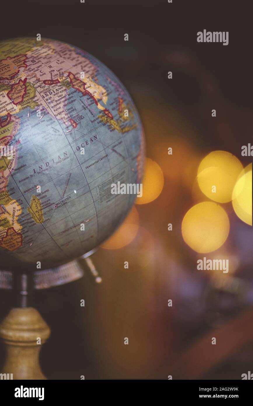 A vertical closeup shot of a desk globe with a blurred background Stock Photo