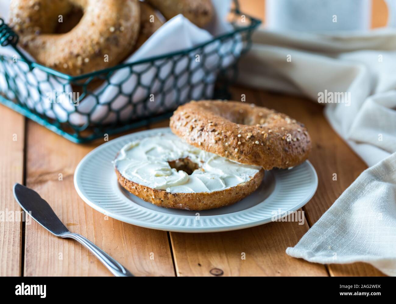 A multigrain bagel with cream cheese. Stock Photo
