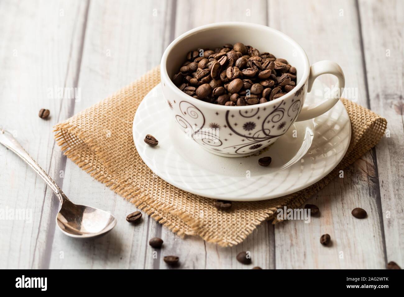 a cup full of coffee beans. Stock Photo