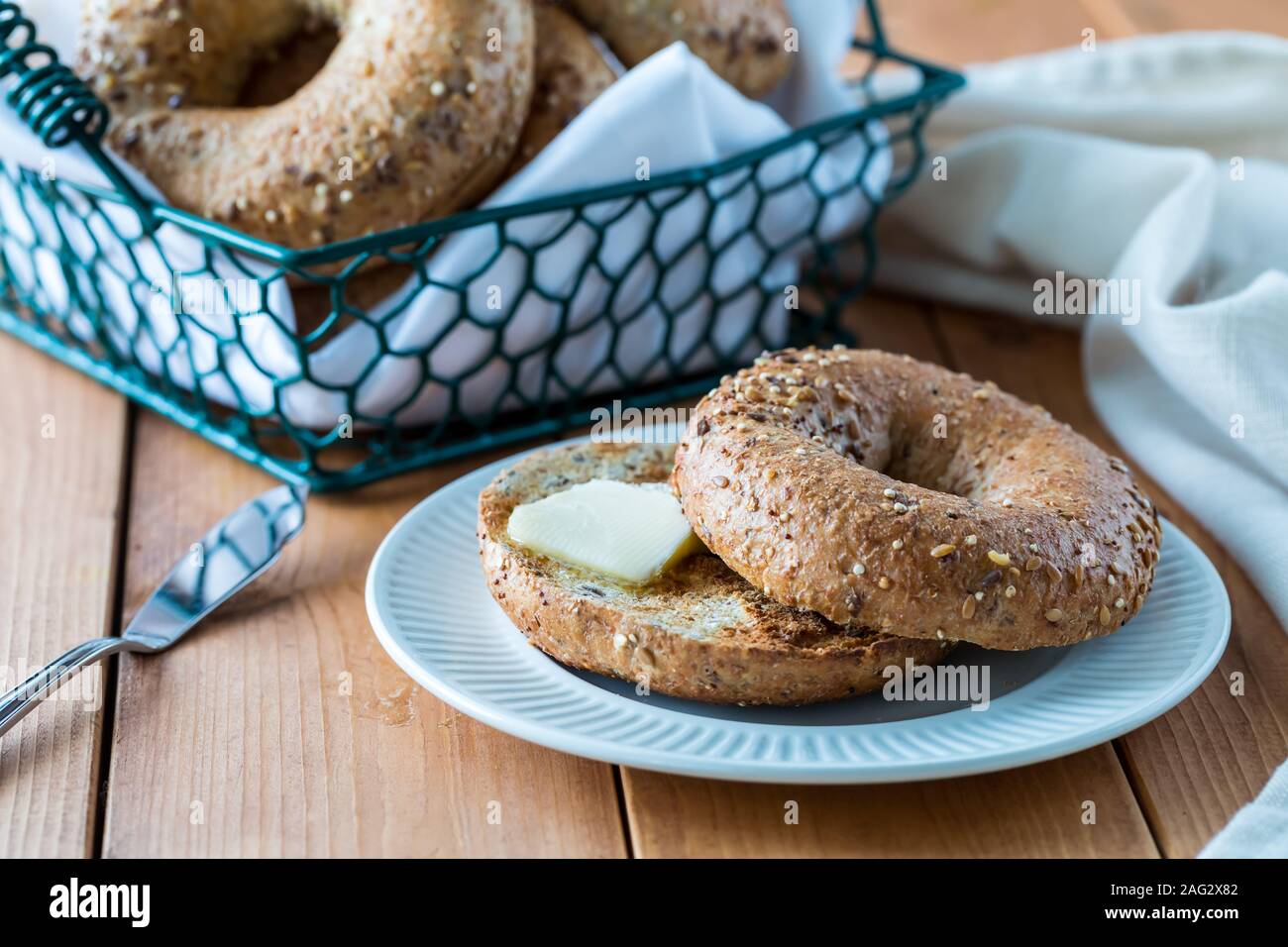 Multi grain bagel and butter. Stock Photo
