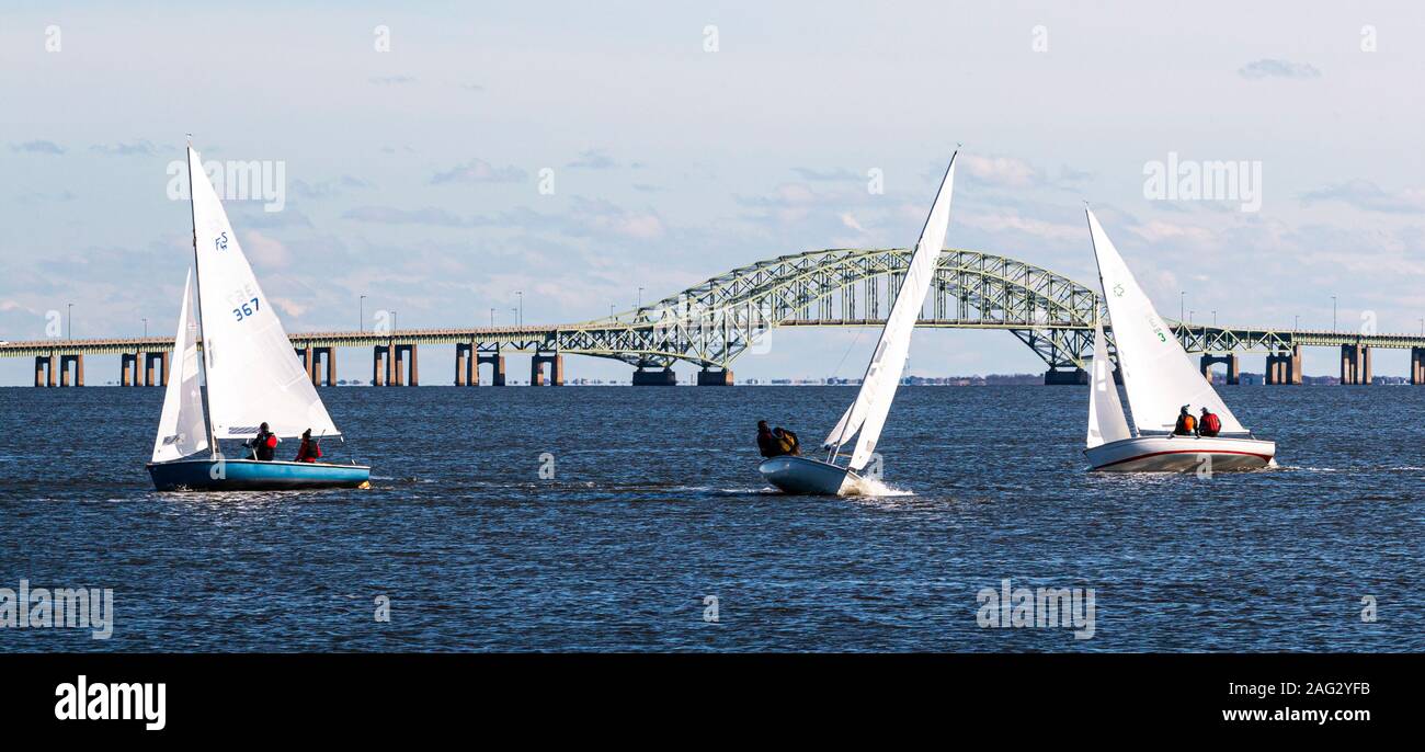 Babylon, New York, USA - 7 December 2019: Three two person sailboats sailing in a windy December Regatta on the waters of the great south bay with the Stock Photo