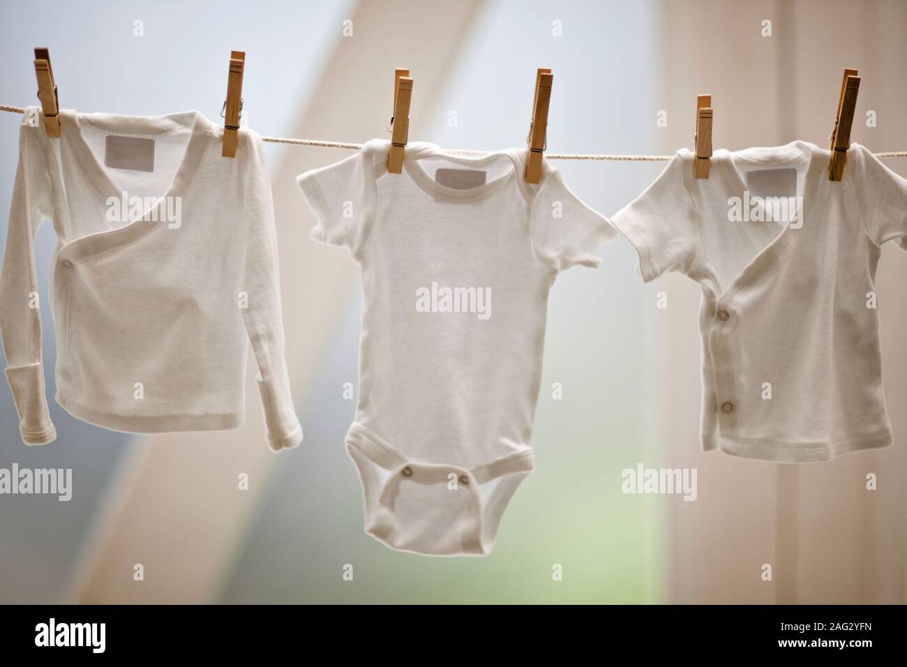 Baby clothes drying on washing line Stock Photo Alamy