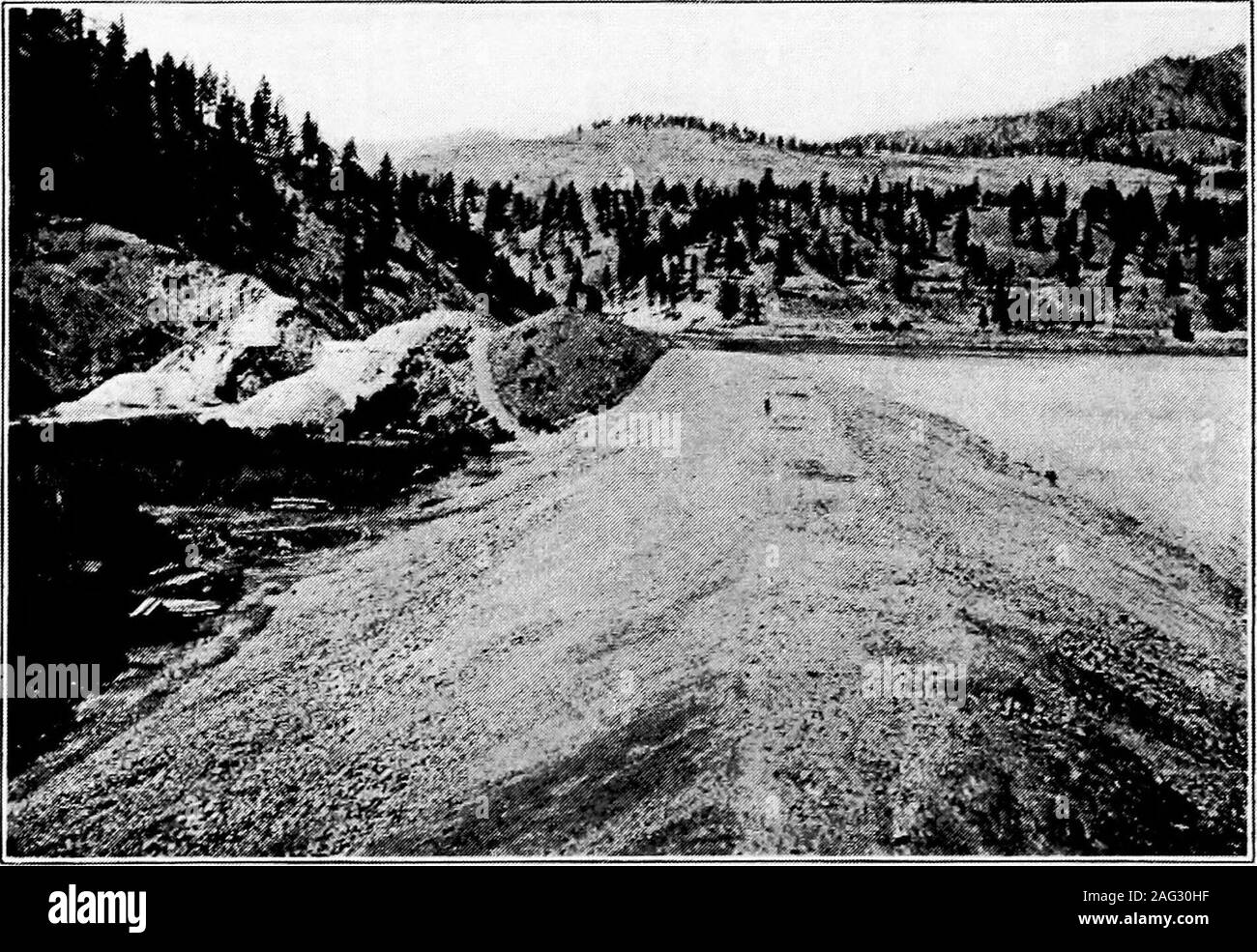 . Principles of irrigation engineering, arid lands, water supply, storage works, dams, canals, water rights and products. Fig. C-—Hydraulic construction of earth dam, giant in foreground washingearth and small rocks into flumes supported on trestles and conveying materialsto site of dam. Okanogan Project, Wash.. Fig. D.—Completed dam built by hydraulic process, shown above. EARTH DAMS 215 kept wetted by hose or other means to a degree sufficient to give themost dense mass possible when compacted. Where large quantities of material are to be handled and especiallywhere the borrow pits are locat Stock Photo