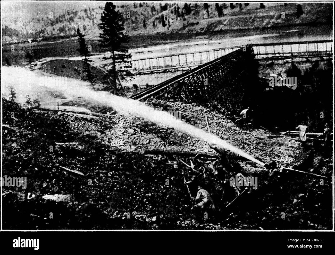 . Principles of irrigation engineering, arid lands, water supply, storage works, dams, canals, water rights and products. Fig. B.—Earth dam partly protected by heavy gravel on water side. Boise Project, Idaho. (Facing Page 214) Plate XIII. Fig. C-—Hydraulic construction of earth dam, giant in foreground washingearth and small rocks into flumes supported on trestles and conveying materialsto site of dam. Okanogan Project, Wash. Stock Photo