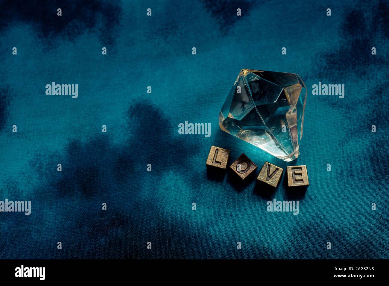 Fake diamond beside love wording with metal letters Stock Photo