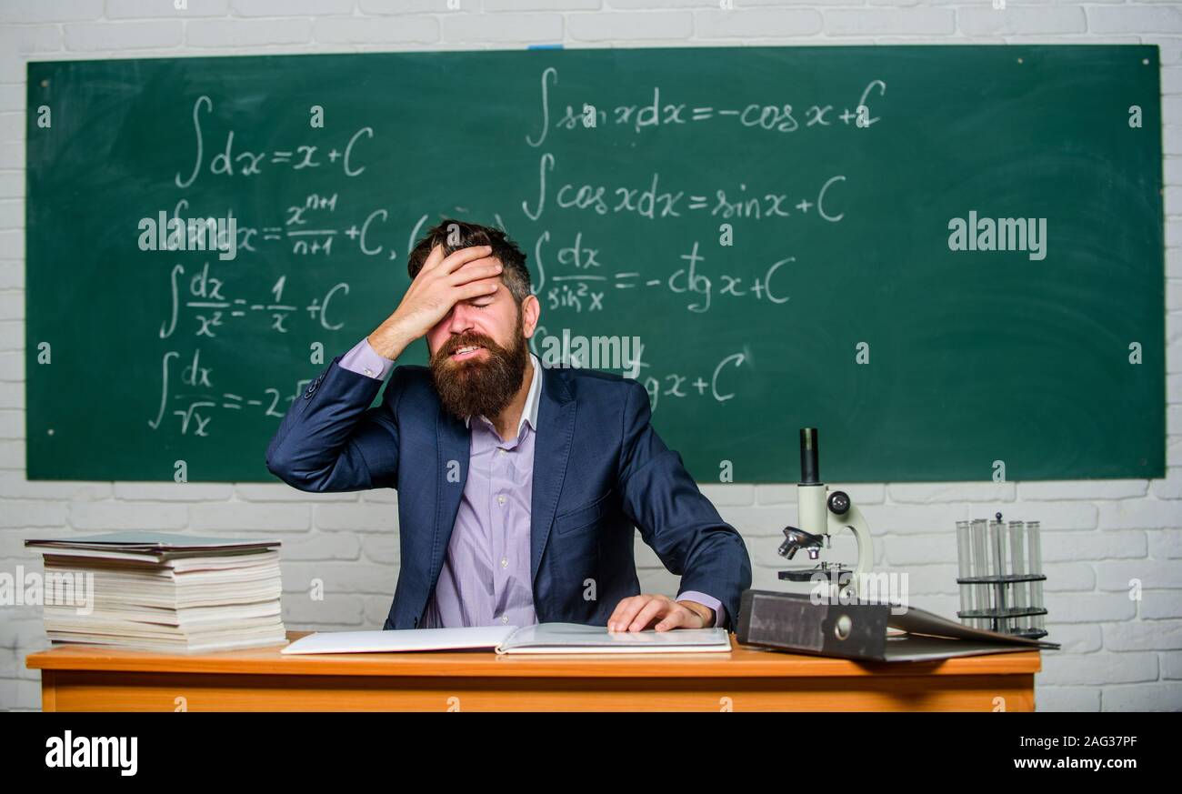 Fed up. Man desperate teacher in classroom. No hope for better. Tired and exhausted. Teaching
