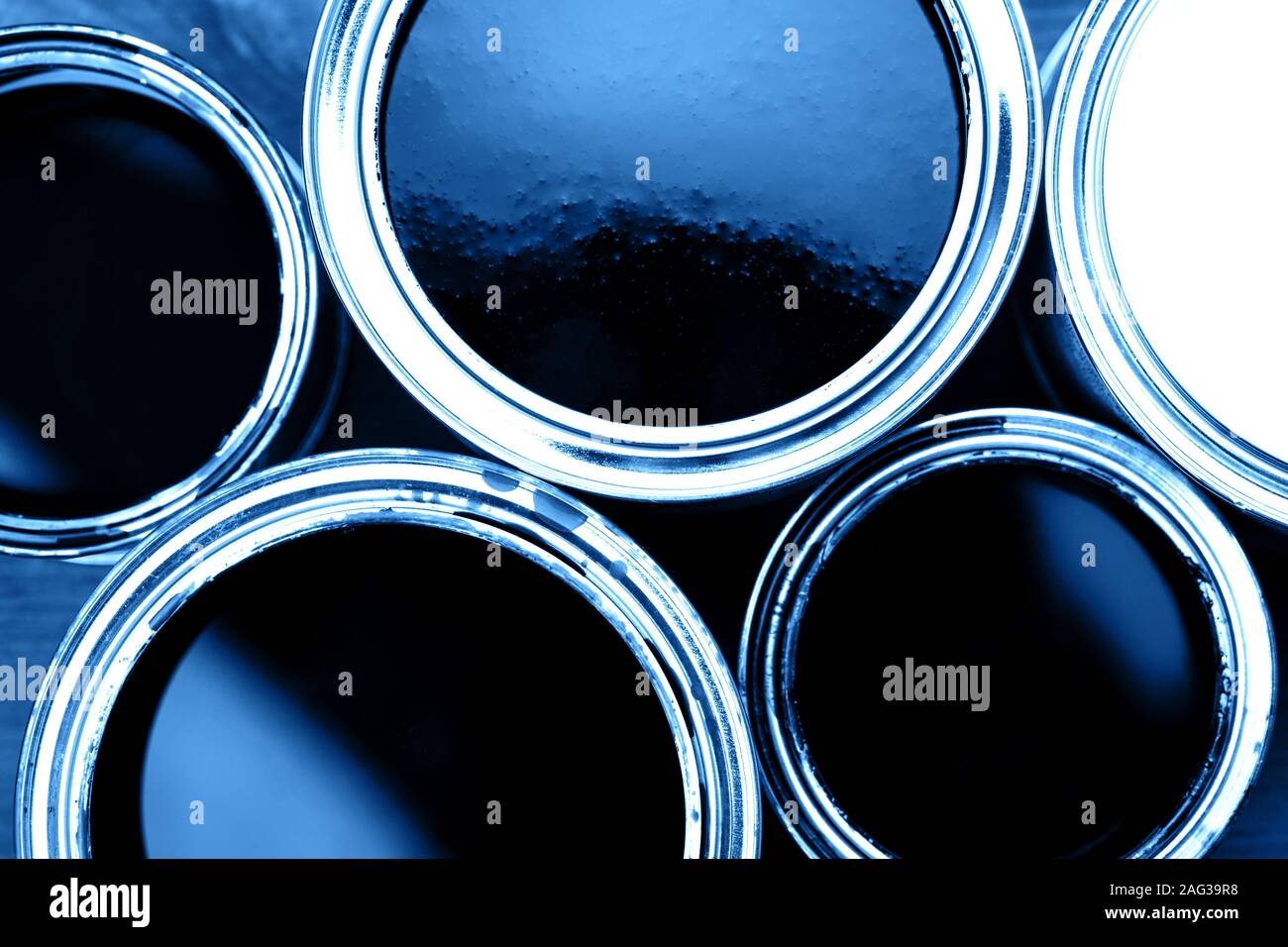 Several opened cans with blue paint inside. Close up. Top View Stock Photo