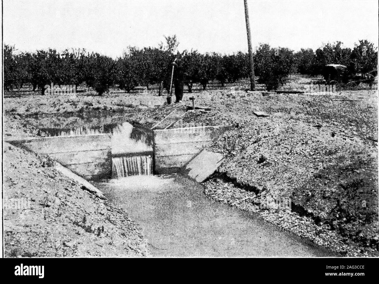 . Principles of irrigation engineering, arid lands, water supply, storage works, dams, canals, water rights and products. Fig. a.—Distributing laterals with wooden boxes and gates, typical of thepioneer work in irrigation. Yakima Project, Wash.. Fig. B.—Concrete box and drop on distributory in place of earlier form ofwooden construction. Orland Project, Cal. {Facing Page no) Plate VIII Stock Photo