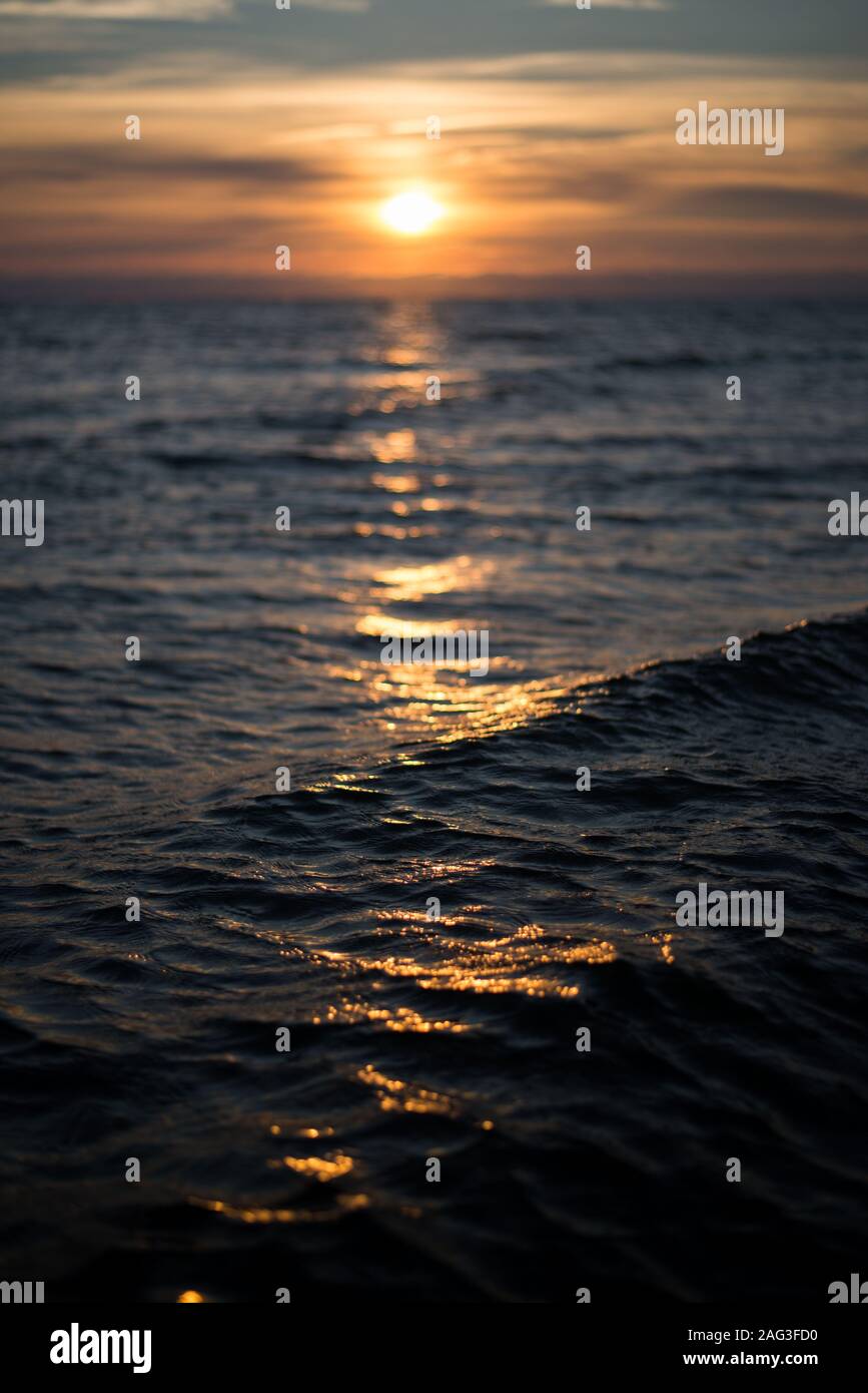 Beautiful scenery of the breathtaking sunset reflected in the sea ...