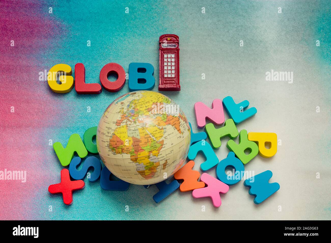 Globe, phone booth and colorful letters on a colorful background Stock Photo