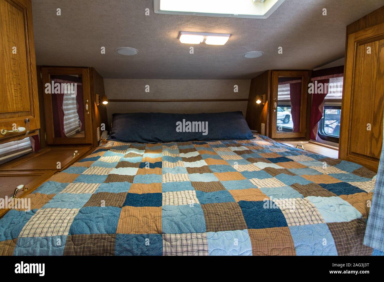 Interior of an Artic Fox truck camper showing the over-cab queen bed. Stock Photo