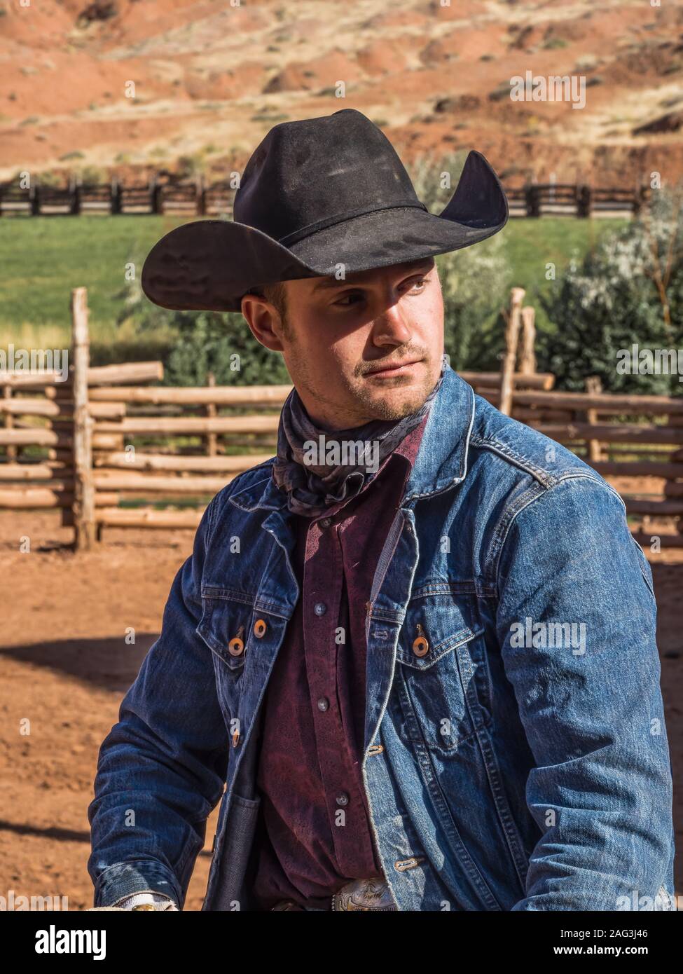 A working cowboy wrangler in his cowboy hat and bandana on the Red Cliffs  Ranch near Moab, Utah Stock Photo - Alamy